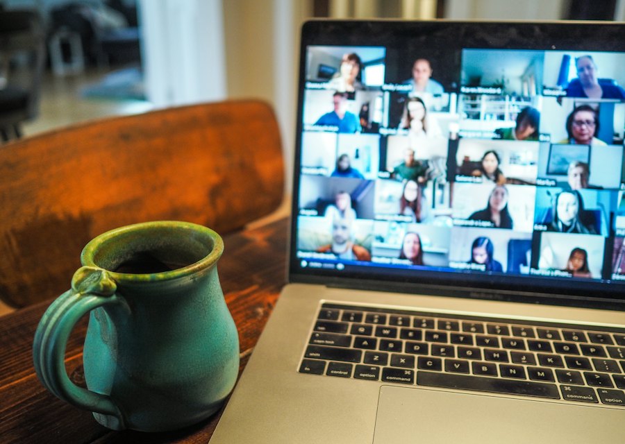 A laptop showing a video class with many students on screen